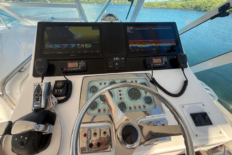 Slide: The Image of Helm of 2003 Cabo 35 Express boat with navigation screens and controls. - 32
