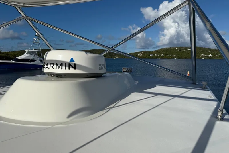 Slide: The Image of 2003 Cabo 35 Express boat with Garmin radar on deck, scenic water view. - 34