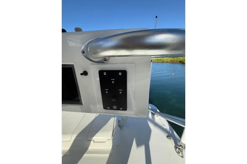 Slide: The Image of Control panel on 2003 Cabo 35 Express boat, overlooking calm water and clear sky. - 36
