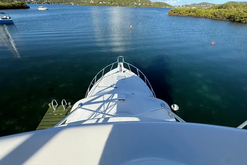 Slide: The Image of Bow view of 2003 Cabo 35 Express yacht on calm water. - 38