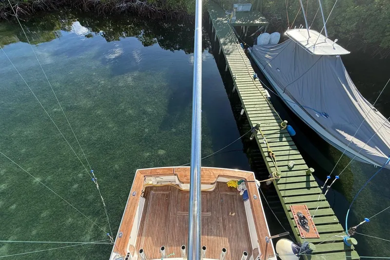 Slide: The Image of Aerial view of a 2003 Cabo 35 Express docked beside a wooden pier. - 5