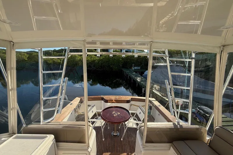 Slide: The Image of Interior view of 2003 Cabo 35 Express yacht with seating and table. - 7