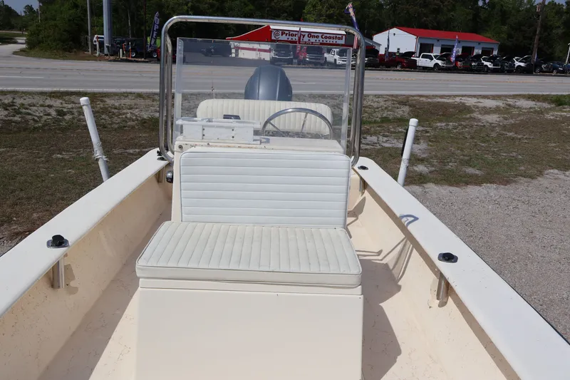Slide: The Image of 2000 JONES BROTHER BATEAU with white seating and steering console. - 12