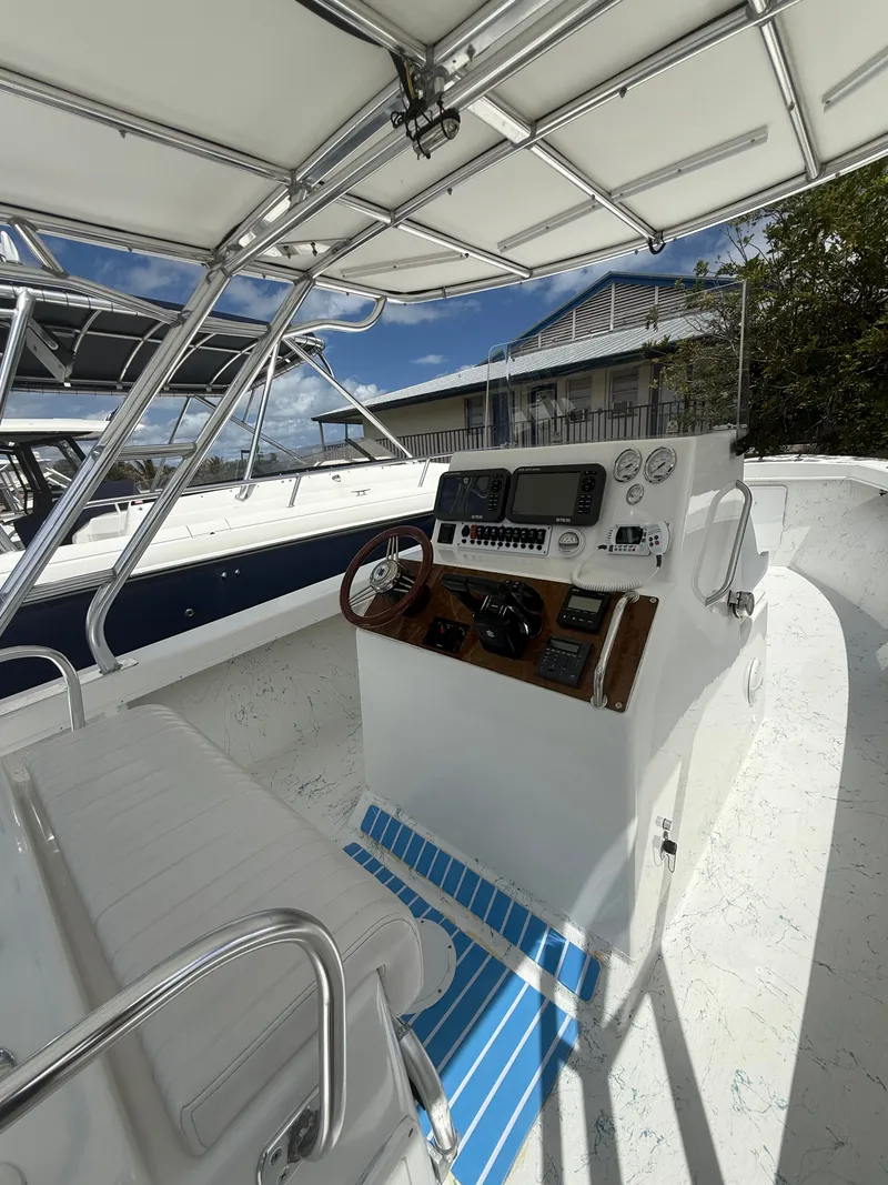 Slide: The Image of C-Hawk Center Console 29, 2021, helm station with instruments and steering wheel. - 10