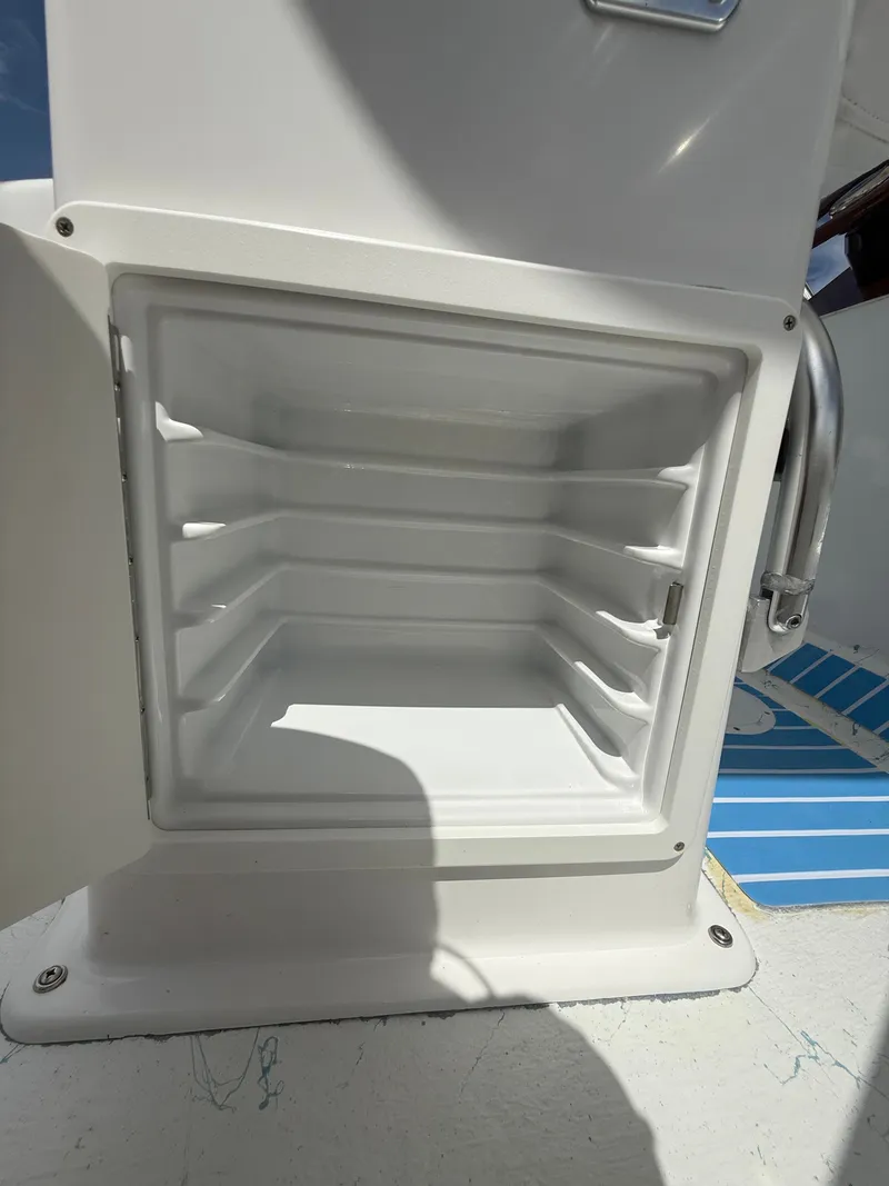 Slide: The Image of Open storage compartment in C-Hawk Center Console 29 boat, 2021 model. - 14