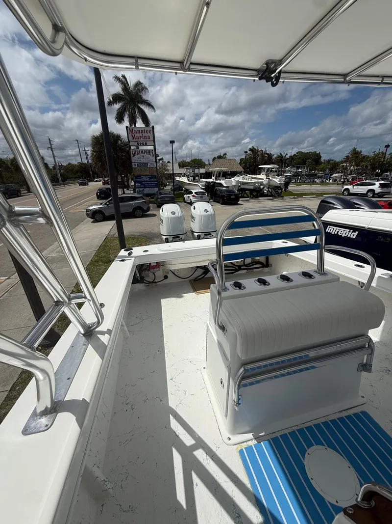 Slide: The Image of C-Hawk Center Console 29 boat, 2021 model, on a sunny parking lot. - 8