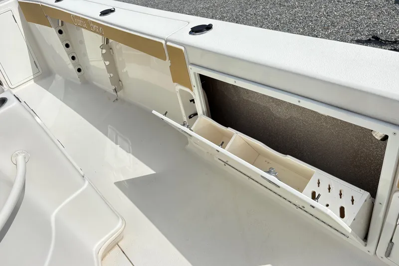 Slide: The Image of 2017 Carolina Skiff Sea Chaser 27 HFC boat storage compartment with open hatch and organizer. - 15