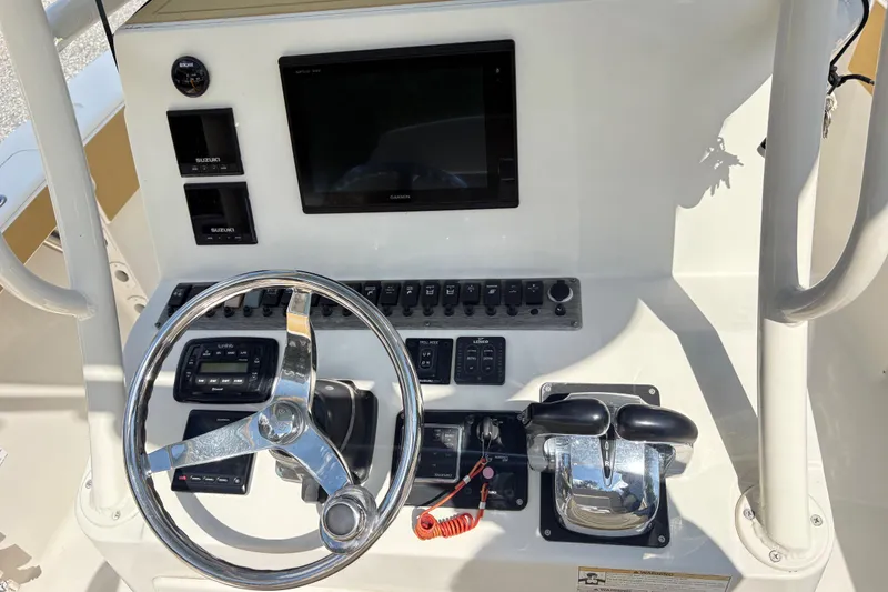 Slide: The Image of 2017 Carolina Skiff Sea Chaser 27 HFC helm with steering wheel and controls. - 16