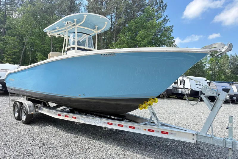 Slide: The Image of 2017 Carolina Skiff Sea Chaser 27 HFC boat on trailer, parked outdoors. - 8