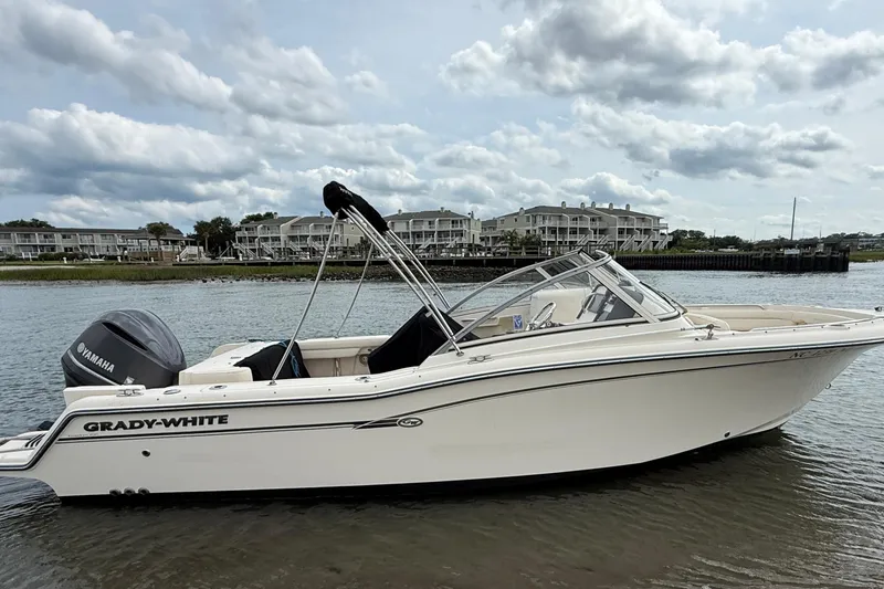 The Image of 2017 Grady-White Freedom 235 boat on water, with Yamaha engine, under cloudy sky. - 1
