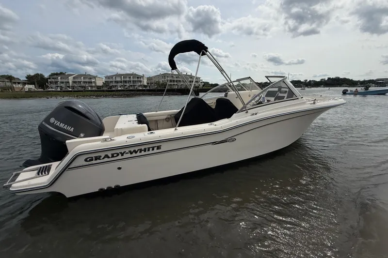 Slide: The Image of 2017 Grady-White Freedom 235 boat with Yamaha engine on calm water. - 16