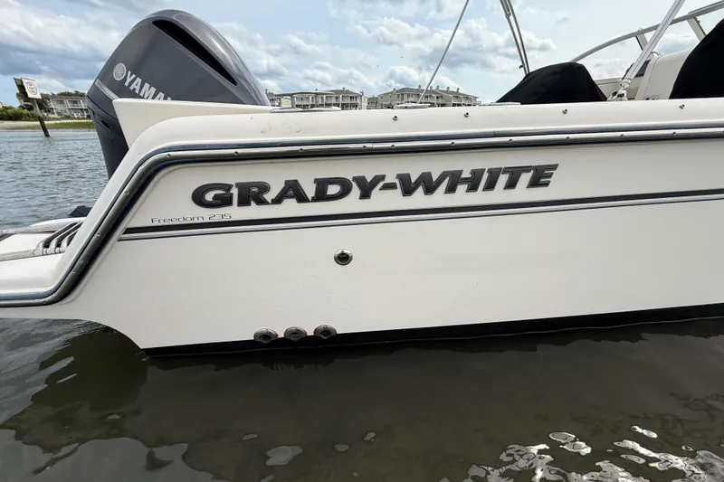 Slide: The Image of 2017 Grady-White Freedom 235 boat on water, featuring Yamaha engine. - 17