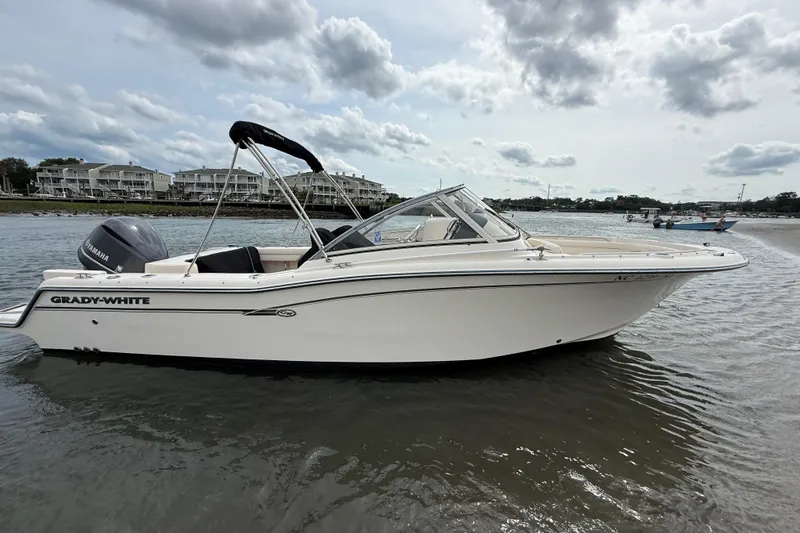 Slide: The Image of 2017 Grady-White Freedom 235 boat on water, showcasing sleek design and Yamaha engine. - 19
