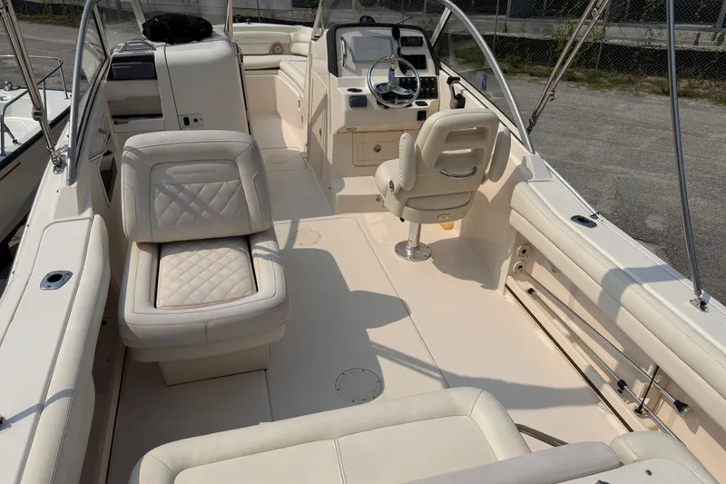 Slide: The Image of 2017 Grady-White Freedom 235 boat interior with seating and steering console. - 34