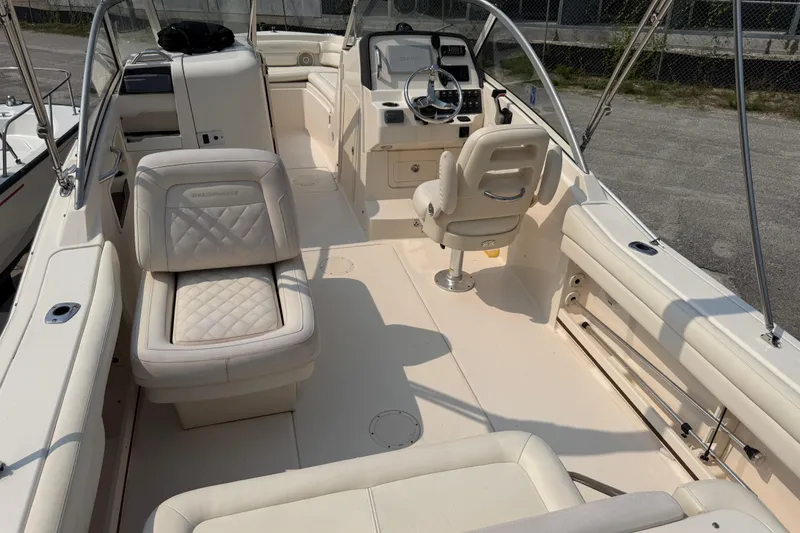 Slide: The Image of 2017 Grady-White Freedom 235 boat interior with plush seating and steering console. - 35