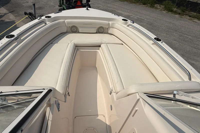 Slide: The Image of 2017 Grady-White Freedom 235 boat interior with cushioned seating and cup holders. - 38