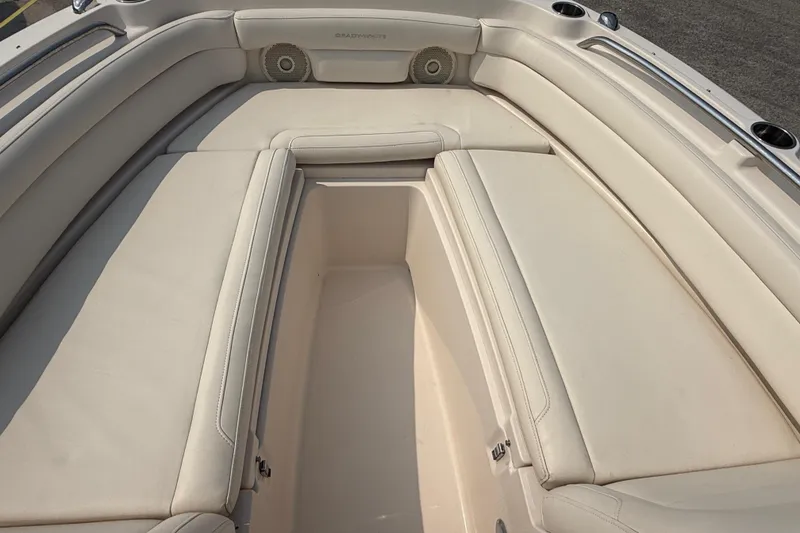 Slide: The Image of 2017 Grady-White Freedom 235 boat interior with beige cushioned seating. - 40
