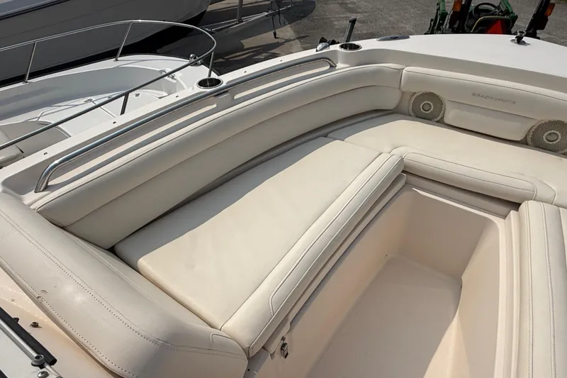 Slide: The Image of 2017 Grady-White Freedom 235 boat interior with cushioned seating and storage compartment. - 42