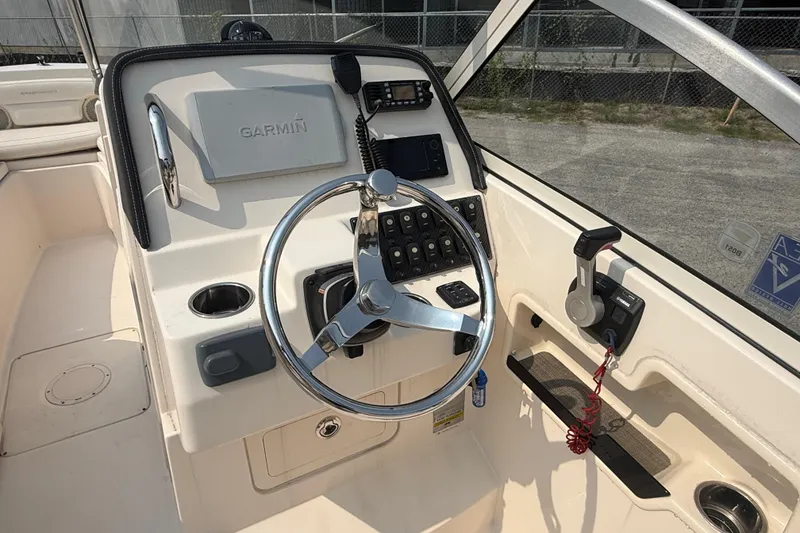 Slide: The Image of 2017 Grady-White Freedom 235 boat helm with Garmin navigation system and steering wheel. - 44