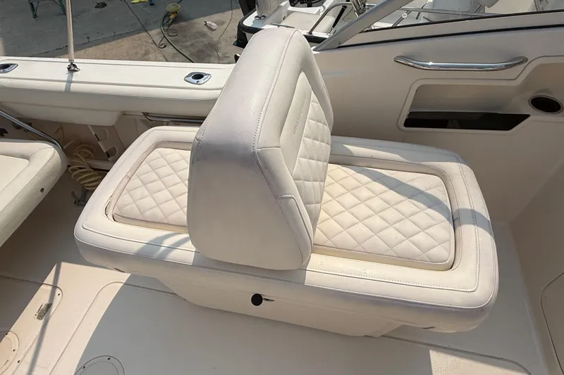 Slide: The Image of 2017 Grady-White Freedom 235 boat seat with quilted white upholstery. - 46