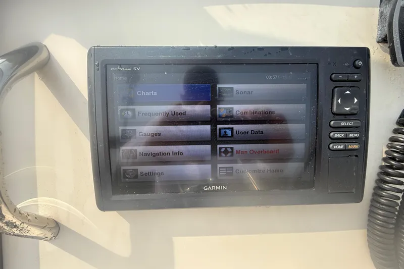 Slide: The Image of Garmin marine GPS display on 2017 Grady-White Freedom 235 boat, showing navigation options. - 57