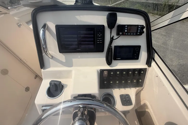 Slide: The Image of 2017 Grady-White Freedom 235 boat dashboard with navigation and communication equipment. - 58