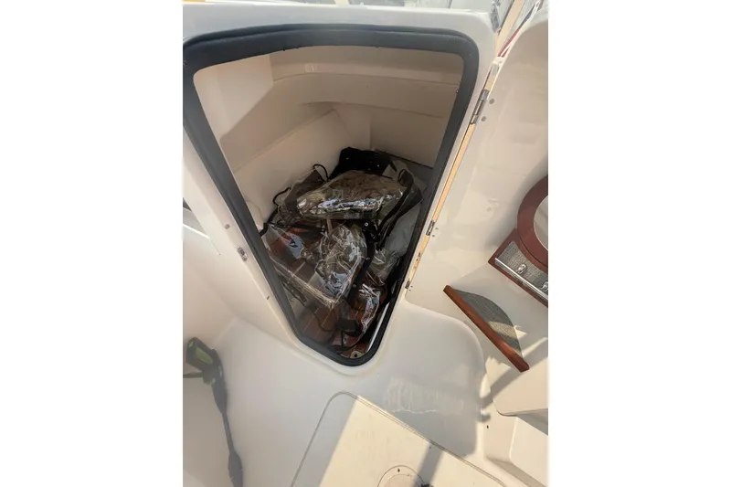 Slide: The Image of Storage compartment of 2017 Grady-White Freedom 235 boat, containing life jackets. - 66