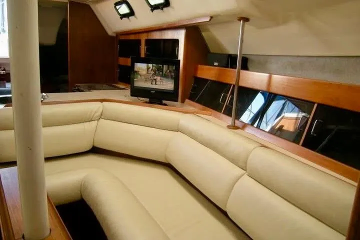 Slide: The Image of Interior of 1987 Hunter Legend 35 yacht with beige seating and mounted TV. - 11