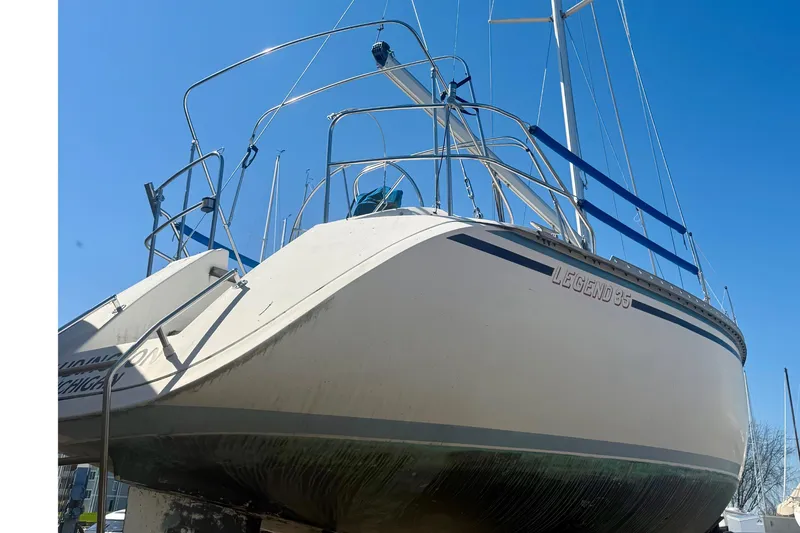 Slide: The Image of 1987 Hunter Legend 35 sailboat on land under clear blue sky. - 5