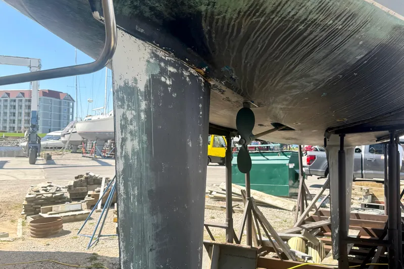 Slide: The Image of 1987 Hunter Legend 35 sailboat under maintenance, showing keel and propeller in a boatyard. - 7