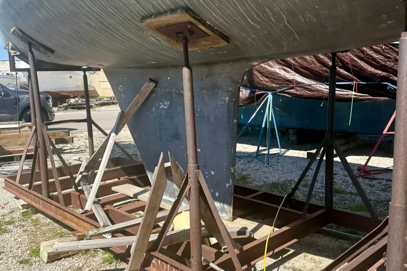 Slide: The Image of 1987 Hunter Legend 35 sailboat keel on stands in a boatyard. - 8