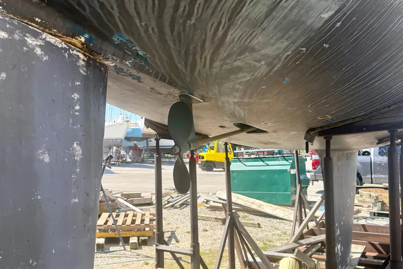 Slide: The Image of 1987 Hunter Legend 35 sailboat hull and propeller in dry dock. - 9