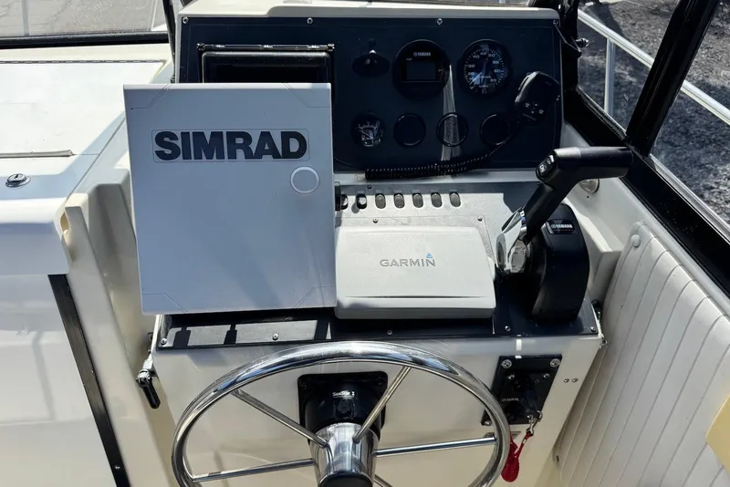 Slide: The Image of Control panel of a 1991 Boston Whaler 21 Conquest R with Simrad and Garmin equipment. - 10