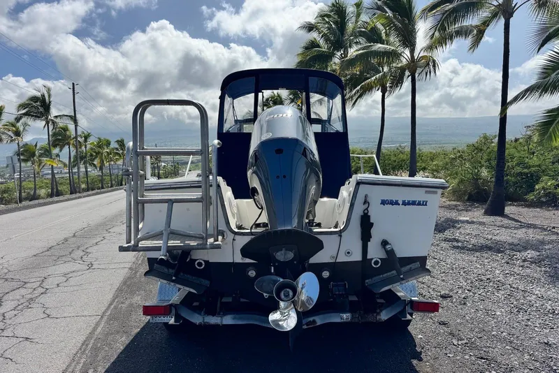 Slide: The Image of 1991 Boston Whaler 21 Conquest R boat on trailer, scenic palm-lined road. - 7