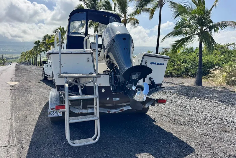 Slide: The Image of 1991 Boston Whaler 21 Conquest R on trailer, parked roadside with palm trees. - 8