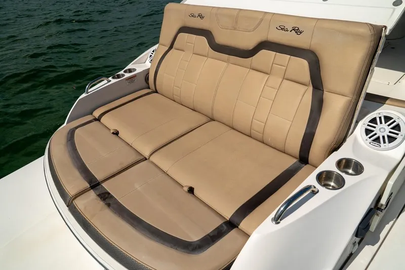 Slide: The Image of Luxurious seating on a 2016 Sea Ray SLX 350 boat, featuring cup holders and speakers. - 14