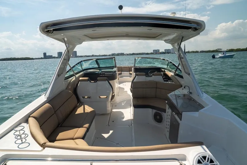 Slide: The Image of 2016 Sea Ray SLX 350 boat interior with spacious seating on open water. - 15