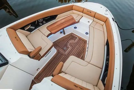 Slide: The Image of Manufacturer Provided Image: 2016 Sea Ray 350 SLX boat interior with luxurious seating and wooden table. - 5