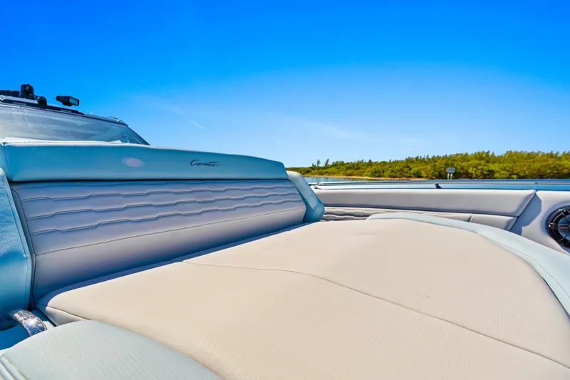 Slide: The Image of 2024 Cigarette 42' Auroris luxury boat interior with sleek seating and clear blue sky. - 11