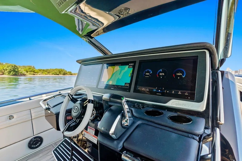 Slide: The Image of 2024 Cigarette 42' Auroris boat dashboard with advanced navigation screens and controls. - 13
