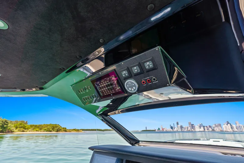 Slide: The Image of Control panel of 2024 Cigarette 42' Auroris boat with city skyline view. - 16