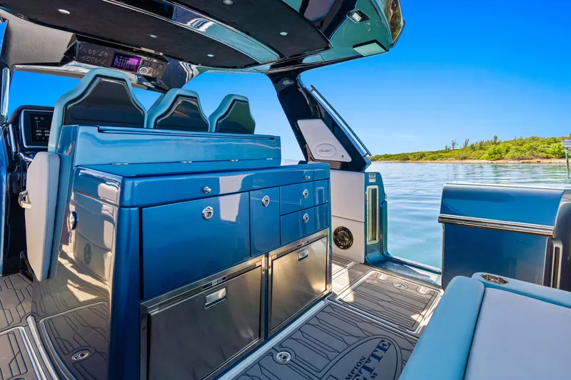 Slide: The Image of 2024 Cigarette 42' Auroris luxury boat interior with sleek blue cabinetry and seating. - 18