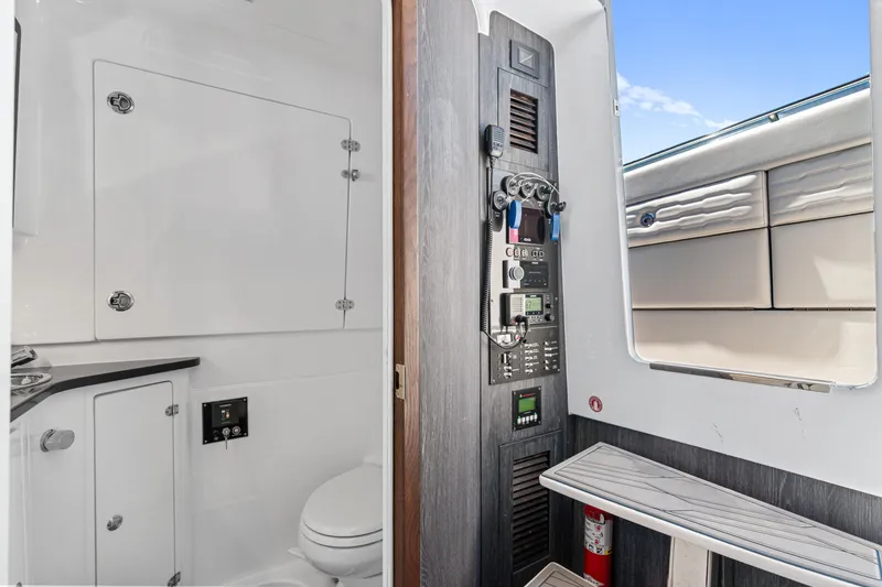 Slide: The Image of 2024 Cigarette 42' Auroris interior with control panel and compact bathroom. - 23