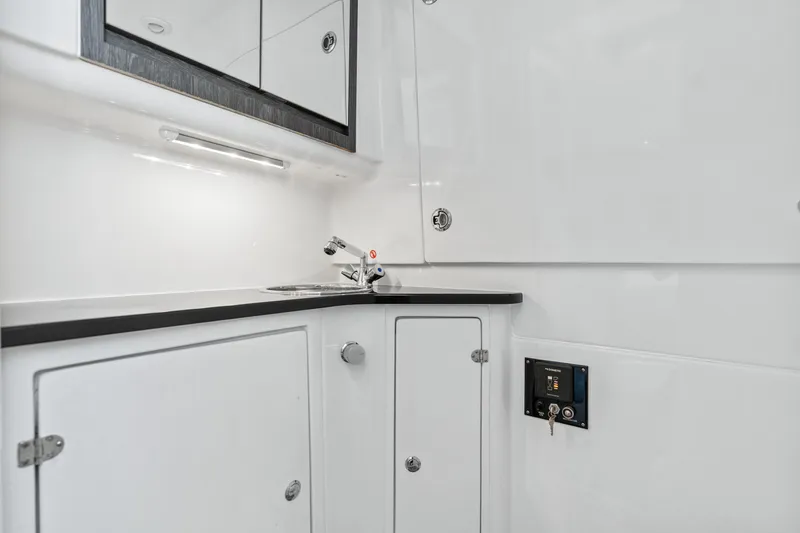 Slide: The Image of 2024 Cigarette 42' Auroris yacht interior with sleek white cabinetry and modern sink. - 29