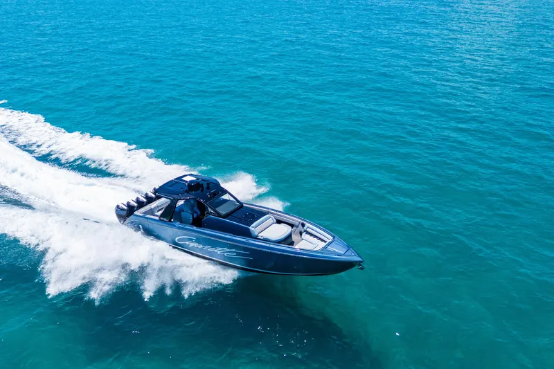 Slide: The Image of 2024 Cigarette 42' Auroris speedboat cruising on clear blue ocean waters. - 4