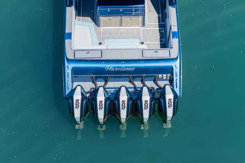 Slide: The Image of 2024 Cigarette 42' Auroris boat with four powerful outboard engines on turquoise water. - 7