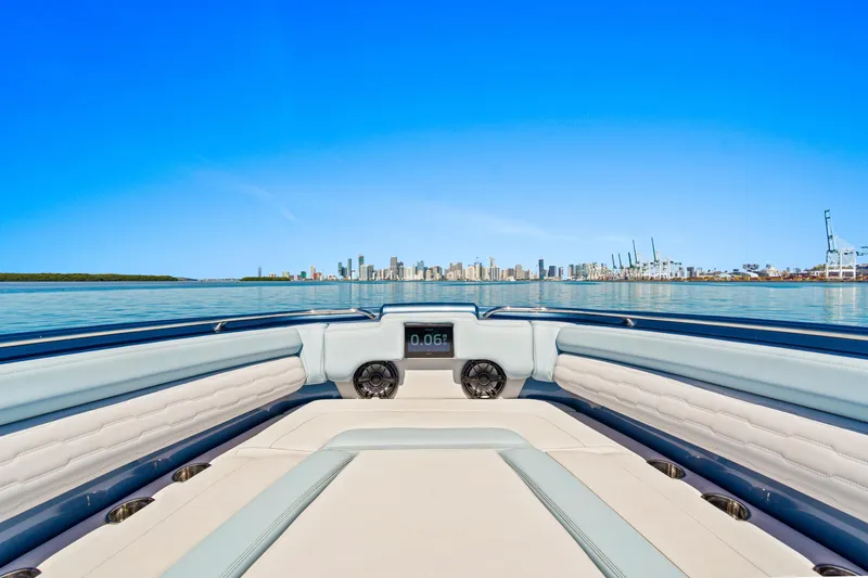 Slide: The Image of 2024 Cigarette 42' Auroris boat with city skyline in the background. - 8