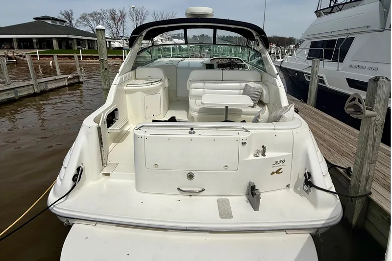 Slide: The Image of 1996 Sea Ray boat docked, featuring spacious seating and sleek design. - 10