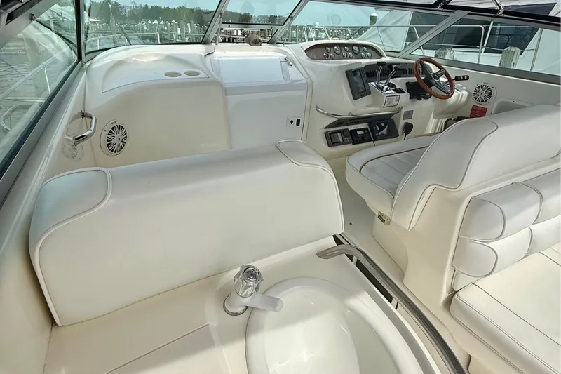 Slide: The Image of 1996 Sea Ray boat interior with white seating, steering wheel, and control panel. - 11