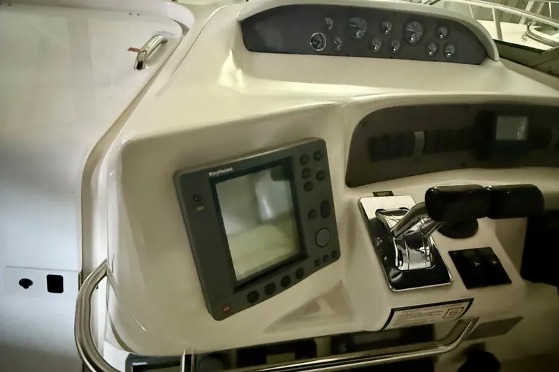 Slide: The Image of 1996 Sea Ray boat dashboard with navigation controls and display panel. - 12